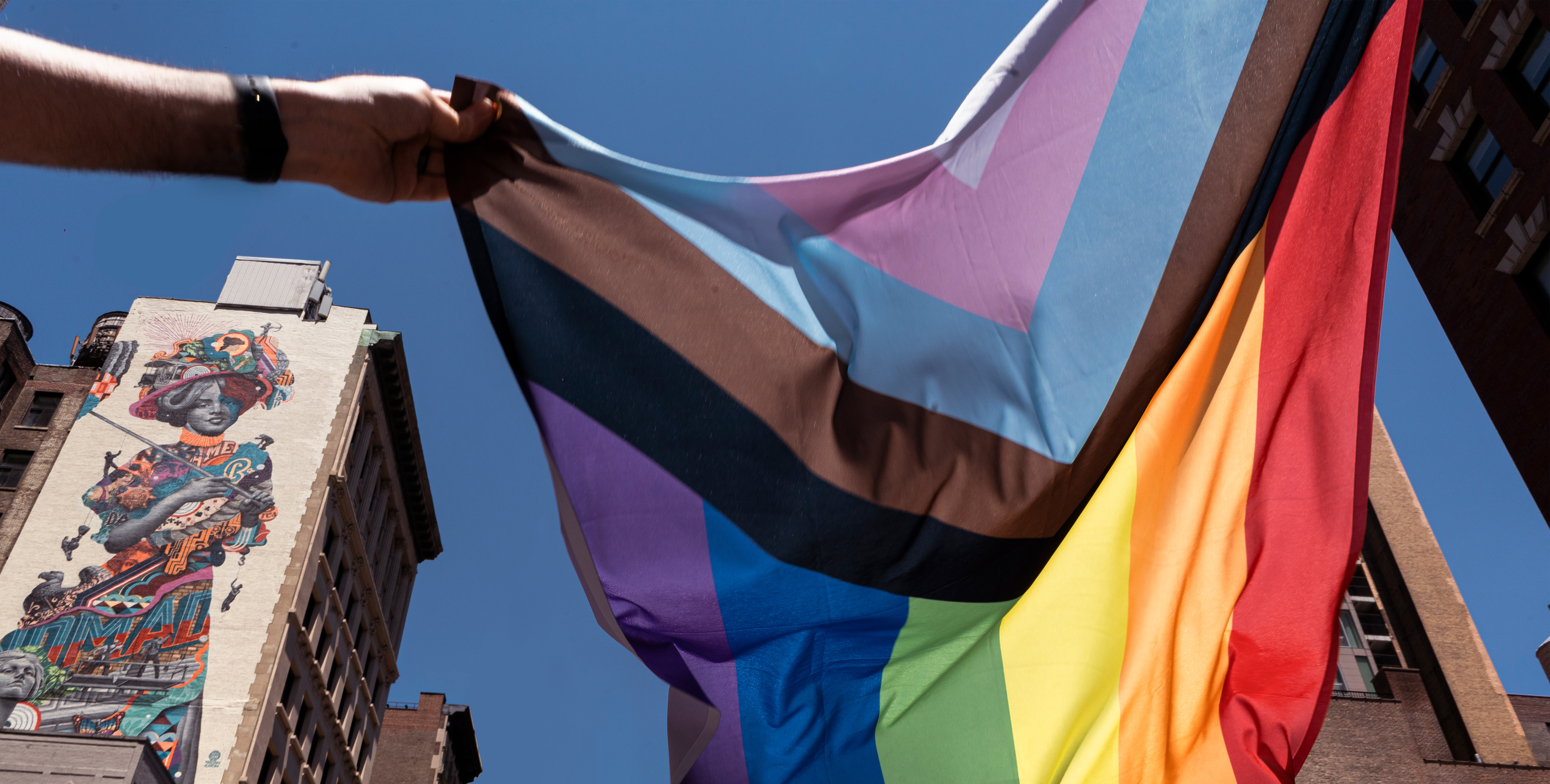 inclusive rainbow flag flying mid air