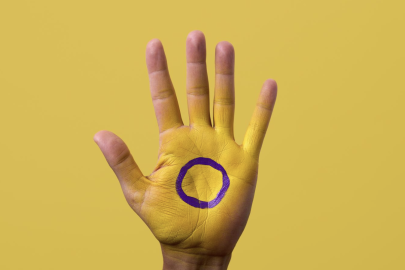 hand with Intersex flag drawn on it