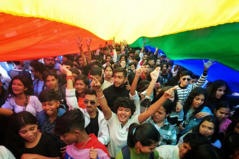 people holding rainbow flag during protest