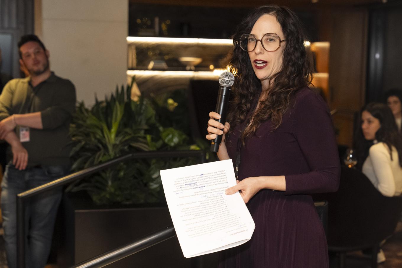 Jessica Stern holding a mic